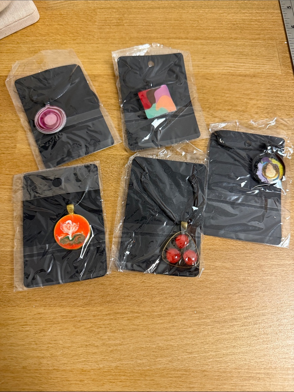 Set of 5 NWT string necklaces with large artistic charms flower dots